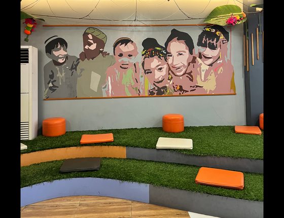 Colorful children's library reading area with mural and soft seating
