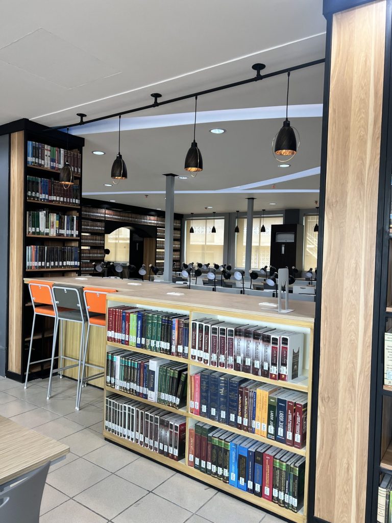 Tall stacks of colorful book spines beside an open reading area
