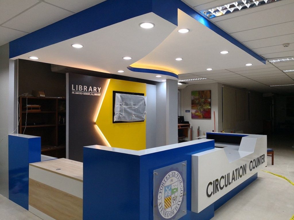 Library circulation counter with the university seal and signage