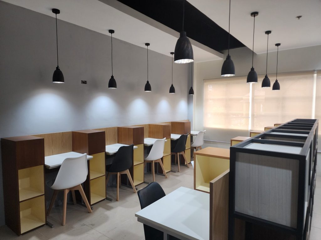 Wood study carrels with white chairs
