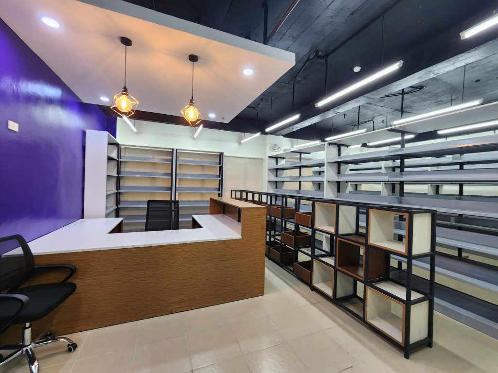 Open circulation desk beside browsable library stacks
