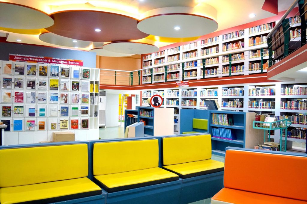 Colorful open stacks with bright yellow and orange lounge seating