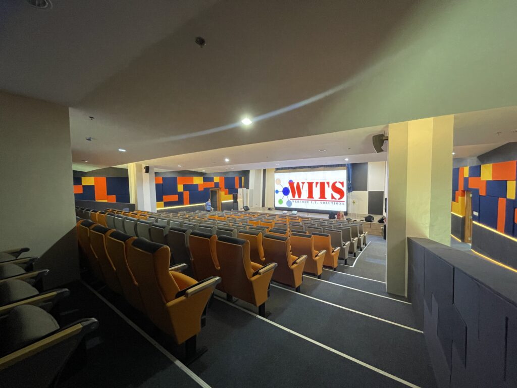WITS-equipped presentation theater with tiered seating and large screens