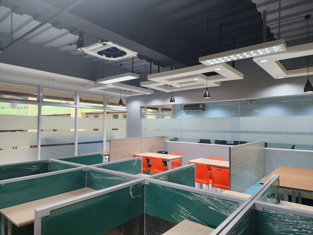 Rows of teal study booths for individual work