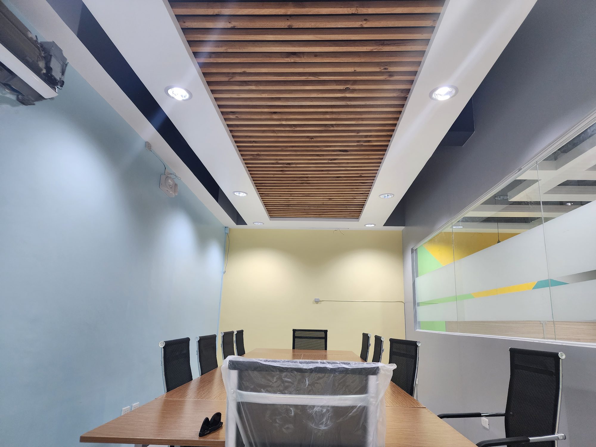 Warm wood-panelled discussion room with a conference table
