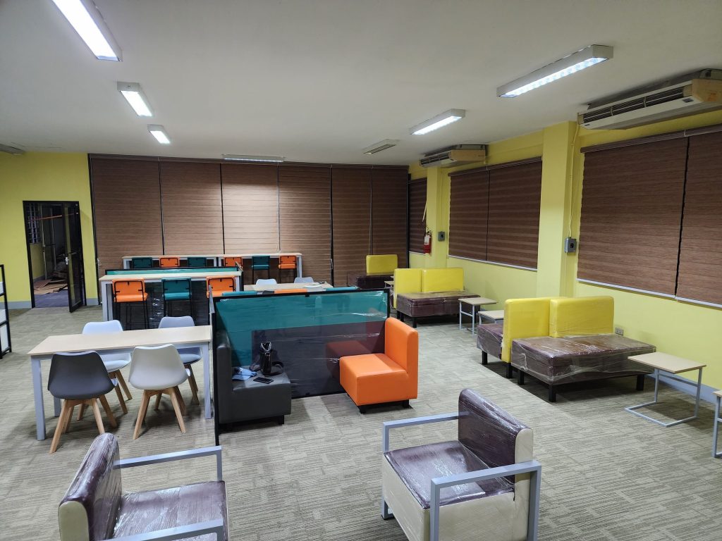 Cozy lounge with soft armchairs and group tables
