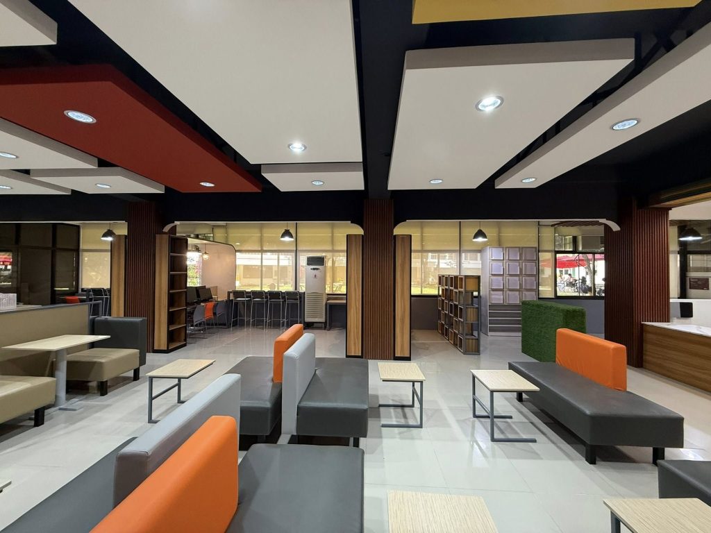 Study area with angular white ceiling panels and booth seating