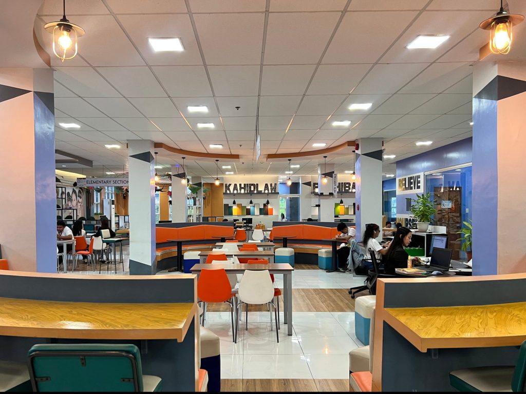 Wide view of the public library interior with colorful lounge seating and bookshelves