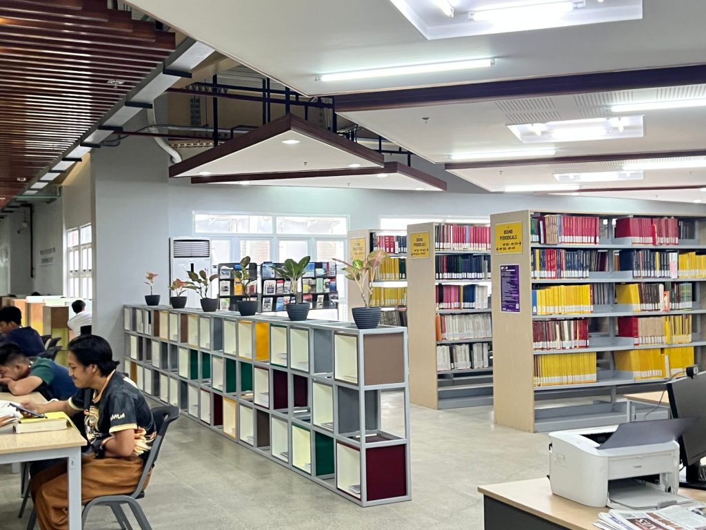 Colorful cube shelving with students browsing and studying