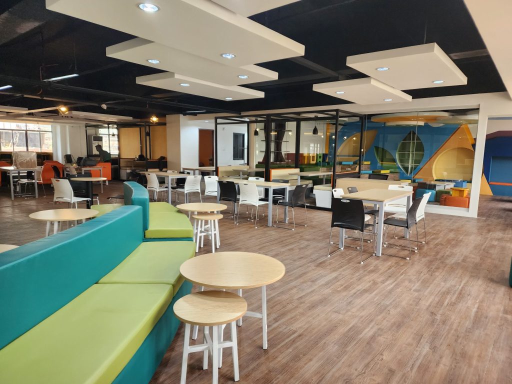 Bright flexible study floor with green booths and colorful seating