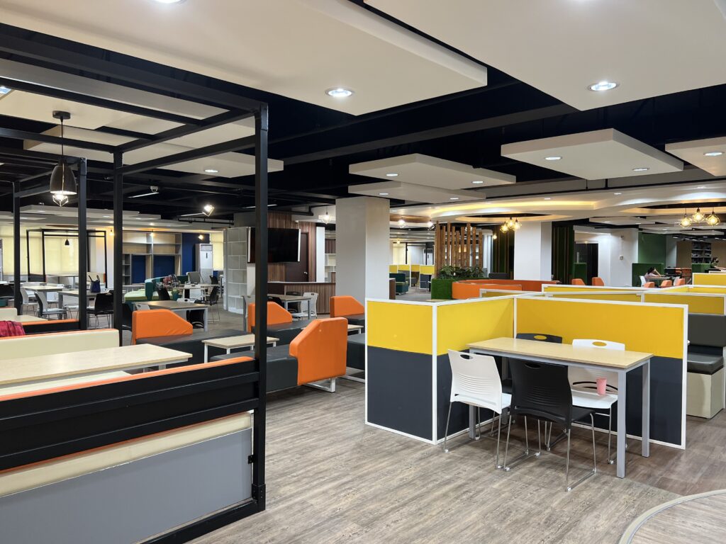 Open learning floor with a curved teal and green seating island