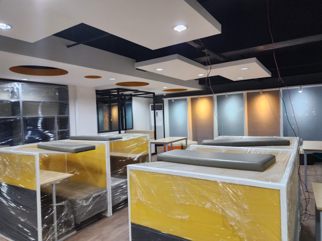 Modern study area with yellow booths beside a staircase